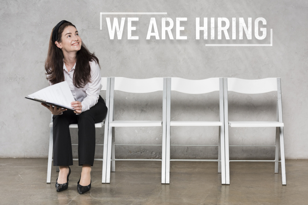 Hiring concept with person standing on chairs